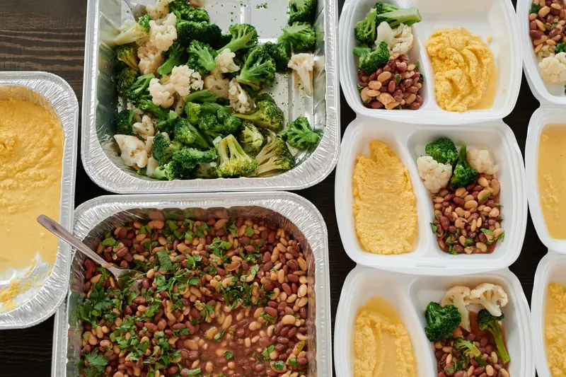 Healthy meal prep with broccoli, beans, and polenta in containers